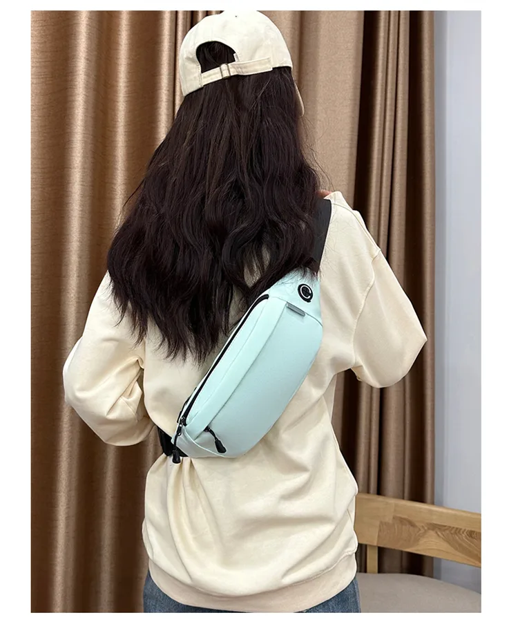 Light blue waist bag worn crossbody over the shoulder